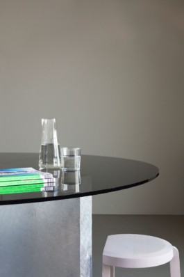 A round table with smoke glass top, a curved galvanized steel staircase and crashed ceiling light for Bus Group Studio, Berlin 2019. Design by ErtlundZull and Atelier Fanelsa. Photo by ErtlundZull and Atelier Fanelsa. ErtlundZull