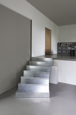 A round table with smoke glass top, a curved galvanized steel staircase and crashed ceiling light for Bus Group Studio, Berlin 2019. Design by ErtlundZull and Atelier Fanelsa. Photo by ErtlundZull and Atelier Fanelsa. ErtlundZull