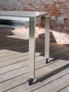 Development and production of three stainless steel tables with an integrated fireplace and rotatable arms with hooks to hang cheese over heat, a glass vitrine and small storage spaces by ErtlundZull. Development and production of three wall mounted stainless steel shelves and a four-legged roof by ErtlundZull, Gerswalde 2021. Concept by Argument GmbH. Photos by Studio Bowie. ErtlundZull