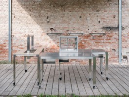 Development and production of three stainless steel tables with an integrated fireplace and rotatable arms with hooks to hang cheese over heat, a glass vitrine and small storage spaces by ErtlundZull. Development and production of three wall mounted stainless steel shelves and a four-legged roof by ErtlundZull, Gerswalde 2021. Concept by Argument GmbH. Photos by Studio Bowie. ErtlundZull