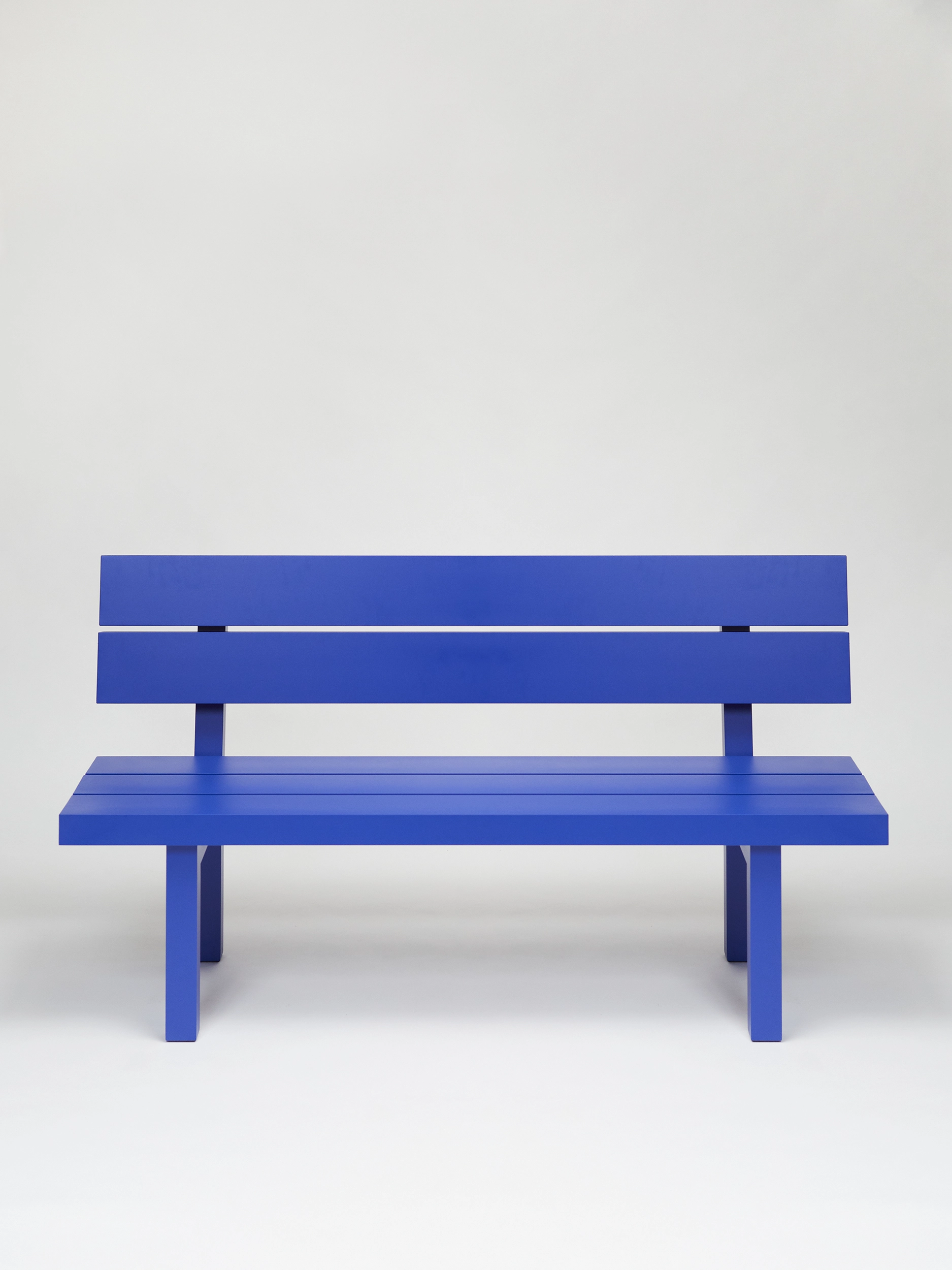 Big blue bench with backrest from the aluminium furniture series Pretending It's Wood in a white studio. Designed by ErtlundZull. Photographed by Robert Hamcher. ErtlundZull